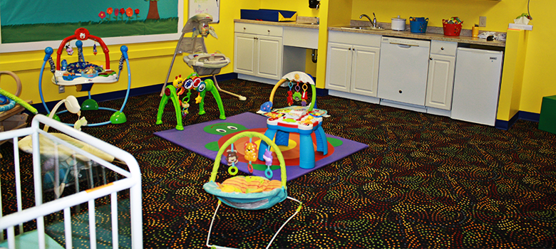 Infant classroom with toys and care equipment